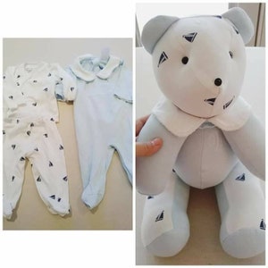 May include: A set of baby clothes with a blue and white sailboat pattern, including a long-sleeved shirt, pants, and a one-piece outfit. A blue and white teddy bear with a sailboat pattern is also included.