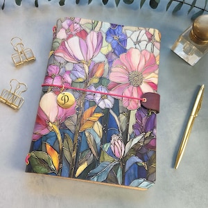 May include: A white ceramic mug with a black handle and the text "But First, Coffee" in a black, handwritten-style font. The mug is on a white surface.