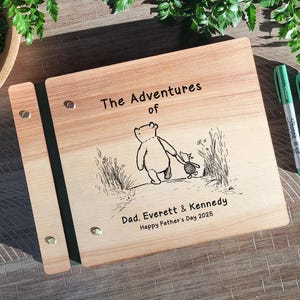 May include: Wooden photo album with the text "The Adventures of" and a Winnie the Pooh illustration. The album is personalized with the names "Dad. Everett & Kennedy" and "Happy Father's Day 2025".
