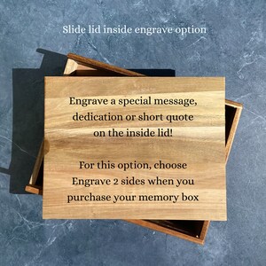May include: A wooden box with a sliding lid. The lid has an option to engrave a special message, dedication, or short quote on the inside. The text on the box reads "Slide lid inside engrave option", "Engrave a special message, dedication or short quote on the inside lid!" and "For this option, choose Engrave 2 sides when you purchase your memory box".