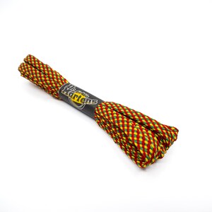 May include: Red, yellow, and green striped shoelaces with a black Dr. Martens label.