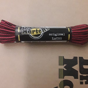 May include: A package of black and red striped shoelaces with the text "Dr. Martens original laces" on the label.