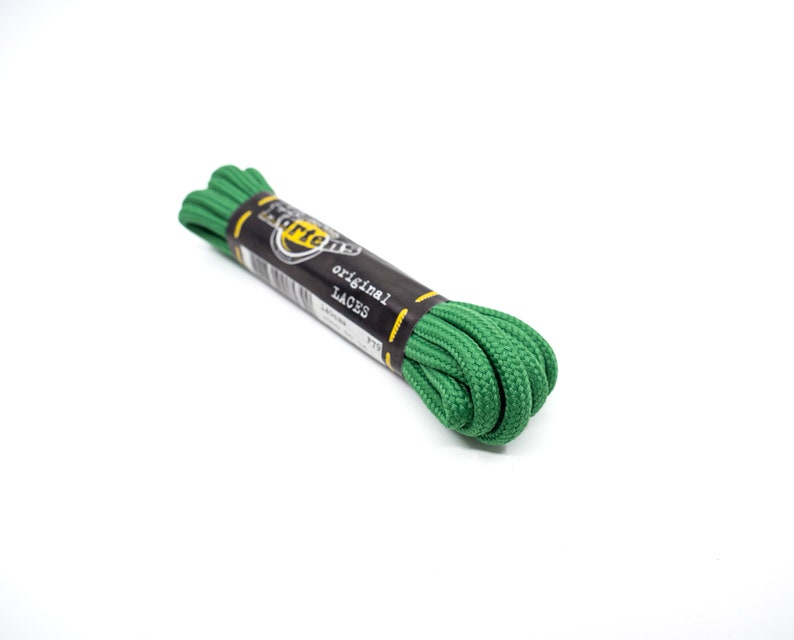 May include: Green shoelaces for Dr. Martens boots. The laces are rolled up and tied with a black tag that says "Dr. Martens original laces".