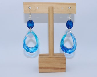 Boucles d'oreilles faites à la main de pendentifs en résine transparente aux accents bleus et perles en résine bleue foncée