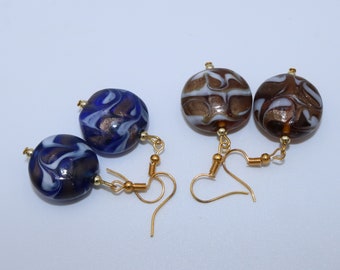 Handmade earrings with beautiful blue or brown glass beads with white and gold patterns in the shape of waves