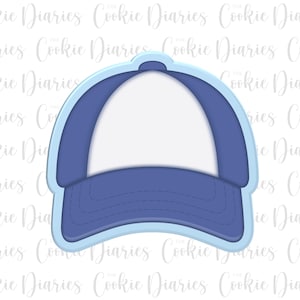 May include: A blue and white baseball cap shaped cookie cutter with a light blue outer border. The design features a central white panel flanked by two blue side panels and a curved blue brim with visible stitching detail along the front edge.