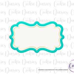 May include: A turquoise blue cookie cutter in the shape of a decorative frame with a gold outline. The frame has a scalloped edge and a slightly curved top and bottom.