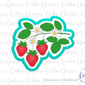 May include: A turquoise blue cookie cutter shaped like a strawberry plant with three strawberries, green leaves, and white flowers.