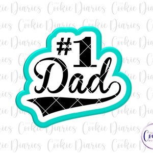 May include: A turquoise blue cookie cutter shaped like a banner with the text "#1 Dad" in black. The number one is in a large font and the word "Dad" is in a cursive font.