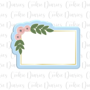 May include: A light blue frame with a gold border and a floral design in the corner. The flowers are pink and the leaves are green.