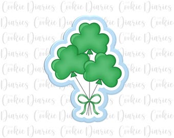 Könnte beinhalten: Ein blauer und grüner Ausstecher in Form eines Shamrock-Ballon-Bouquets. Die Ballons sind mit einem grünen Band zusammengebunden.