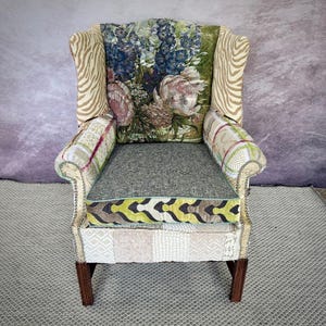 Custom upholstered patchwork chair with ruffle flowers.
