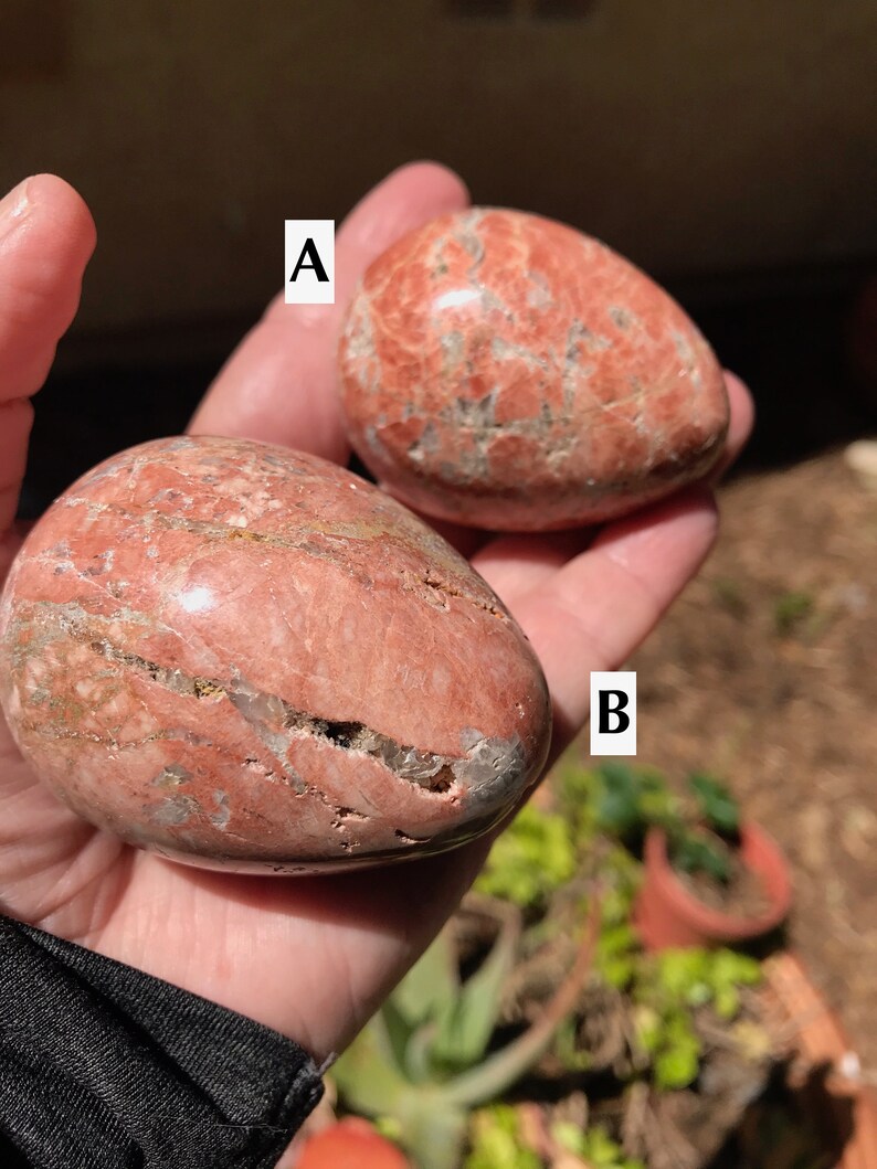 May include: Two red and white striped egg-shaped polished stones labeled A and B.