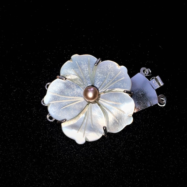 Mother-of-Pearl 3 strand box (tab) clasp with a carved Hibiscus Flower with a 6mm Pink Pearl. An elegant way to finish any jewelry design.