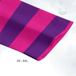 a close-up view of a long-sleeved shirt with a vibrant purple and pink striped pattern.