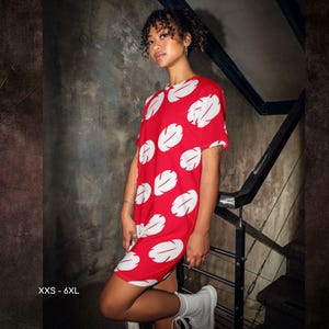 a woman in a red dress posing for a picture