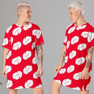 a man with white hair wearing a red dress