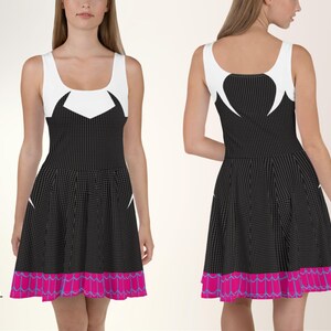 a woman in a black and white dress with pink trim