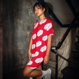 a woman in a red and white dress posing for a picture