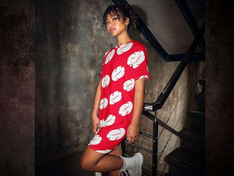 a woman in a red and white dress posing for a picture