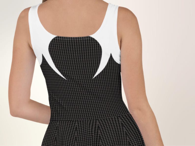 a woman is wearing a black and white dress