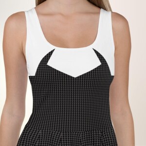 a woman wearing a black and white dress