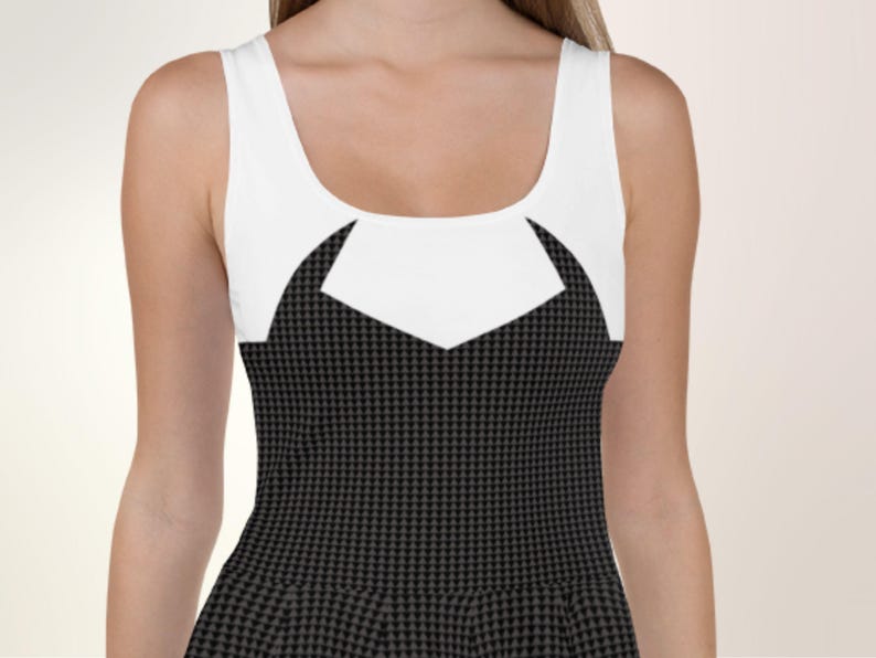 a woman wearing a black and white dress