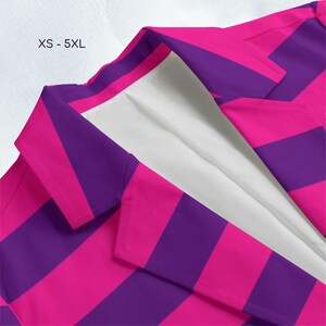 A close-up of a colorful striped fabric, with a mix of pink and purple stripes.