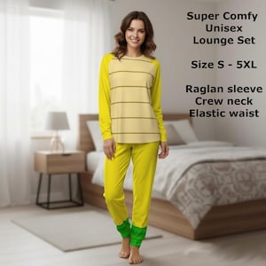 May include: A yellow unisex lounge set with a raglan sleeve and crew neck. The top has horizontal brown stripes. The pants are solid yellow with green cuffs. The text on the image says "Super Comfy Unisex Lounge Set" and "Size S - 5XL".