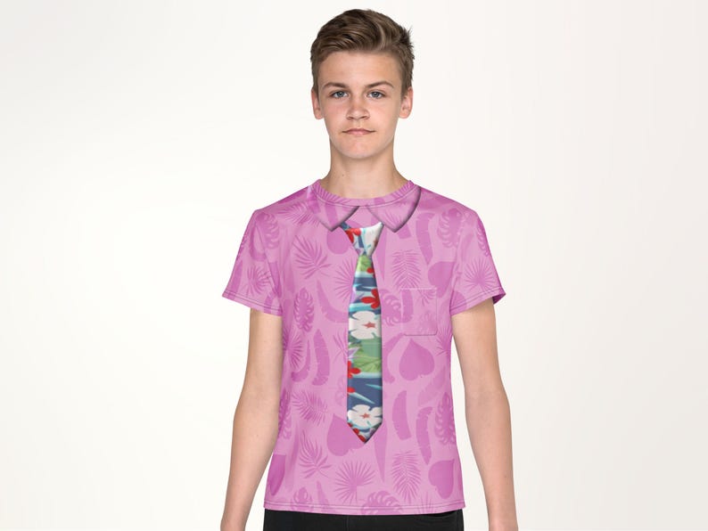 A young boy wearing a pink shirt with a tie printed on it.