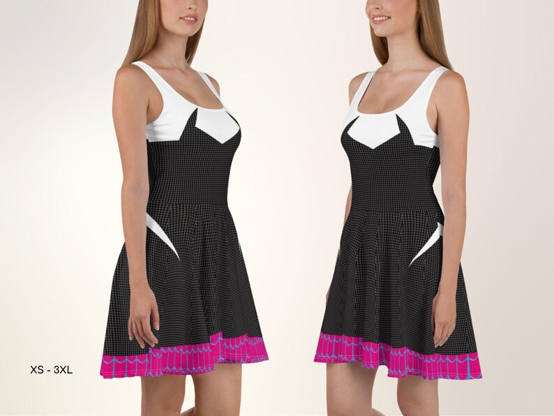 a woman in a black and white dress standing next to another woman