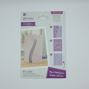 May include: A package of 8 die-cut card making stencils with a floral design. The package is white with purple text and shows the stencils in use. The stencils are 6 inches by 2.6 inches (15.2 cm x 6.6 cm).