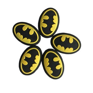 May include: Six black and gold Batman logo rubber stickers.