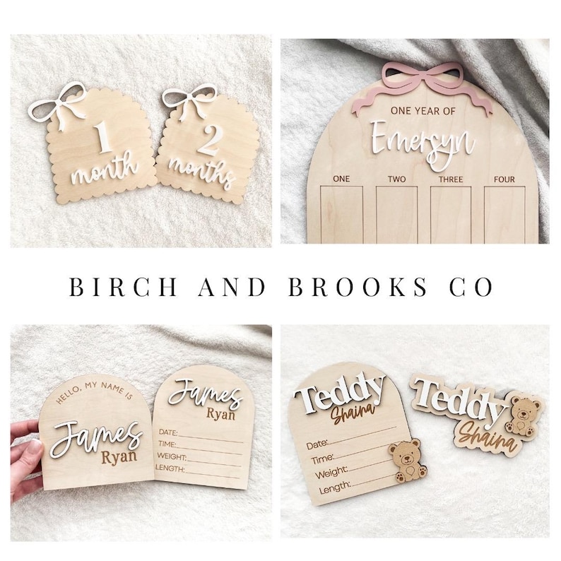 May include: A collection of light-colored wooden milestone and birth announcement plaques featuring arched shapes, white and pink 3D lettering, and engraved details. The plaques include text such as 1 month, 2 months, One Year of Emersyn, Hello My Name Is James Ryan, and Teddy Shaina with bear icons.