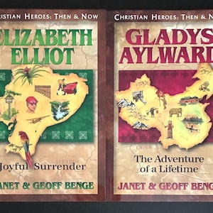 May include: A white ceramic mug with a black handle and the text "But First, Coffee" in a bold, black font. The mug is set against a blurred background, suggesting a cozy setting.