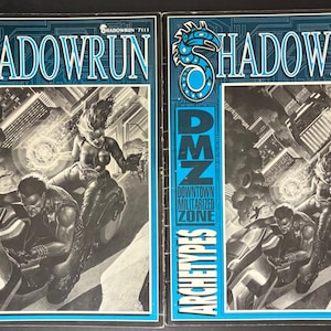 May include: Two Shadowrun role-playing game books, Rule Book and Archetypes, featuring blue and black covers with a circuit board pattern. The central illustration depicts two figures on a motorcycle in a city, with the text DMZ Downtown Militarized Zone.
