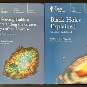 May include: Two course guidebooks from The Great Courses. One is titled "Experiencing Hubble: Understanding the Greatest Images of the Universe." The other is "Black Holes Explained." Both have blue covers with astronomy images.