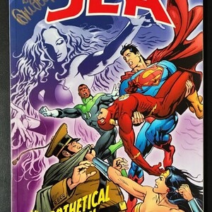 May include: A comic book cover for "JLA" featuring Superman carrying the Flash, with Wonder Woman, Green Lantern, and a military figure. The title "The Hypothetical Woman" is displayed prominently, with the DC logo and author names at the top.