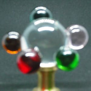 mult color orbs orbiting clear sphere