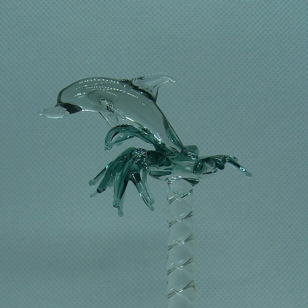 glass dolphin leaping from waves finial