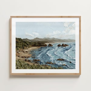 May include: A framed landscape painting of a coastal scene. The artwork depicts a beach with rolling waves, rocky formations, and a mountain range under a cloudy sky. The color palette includes blues, greens, and browns.