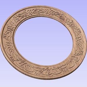 May include: A wooden oval frame with intricate carved floral and leaf patterns. The frame is a light brown color and features a detailed design around the inner and outer edges, creating a decorative border.