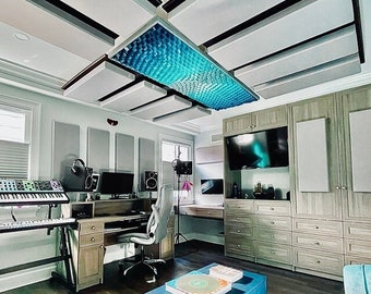 May include: A home recording studio with a desk, computer, keyboard, and a blue acoustic panel ceiling. The room has a couch, a coffee table with books, and a large flat screen TV.