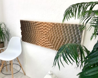 May include: A wall-mounted, 3D wood art piece with a gradient of brown, beige, and green tones. The piece is made up of small, square blocks that create a textured, geometric pattern.