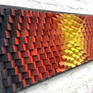 May include: A wall art piece made of wood blocks in a gradient of black, red, orange, and yellow. The blocks are arranged in a wave pattern, creating a 3D effect.