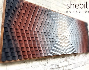 May include: A rectangular wall art piece composed of numerous small wooden blocks of varying heights, creating a textured surface. The blocks feature a color gradient transitioning from black to reddish-brown to white. The text shepit WORKSHOP is visible.