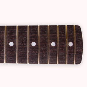May include: A dark brown guitar fretboard with four white dot inlays.