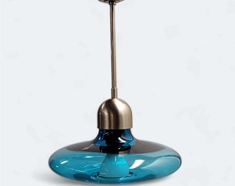 Minimalist ceiling lamp in contemporary style with blue glass shade in a spatial aesthetic.