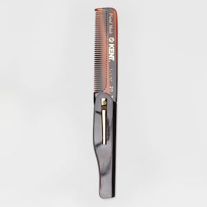 May include: A brown and black comb with gold lettering that reads "Hand Made KENT.  Stout 20T".