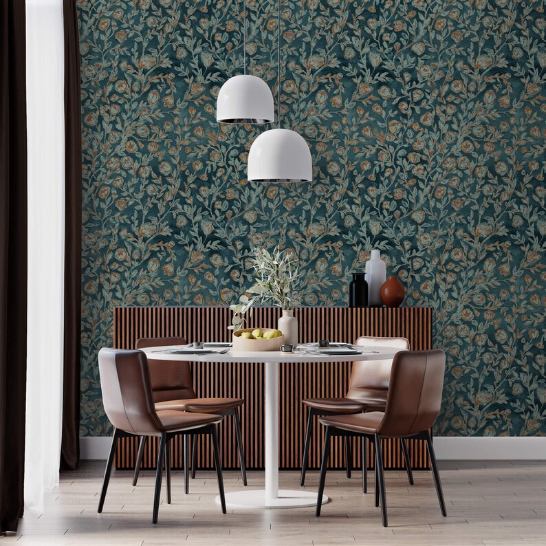 May include: A dining room with a wooden table and four brown leather chairs. The walls are covered in teal wallpaper with a floral pattern. Two white pendant lights hang above the table.